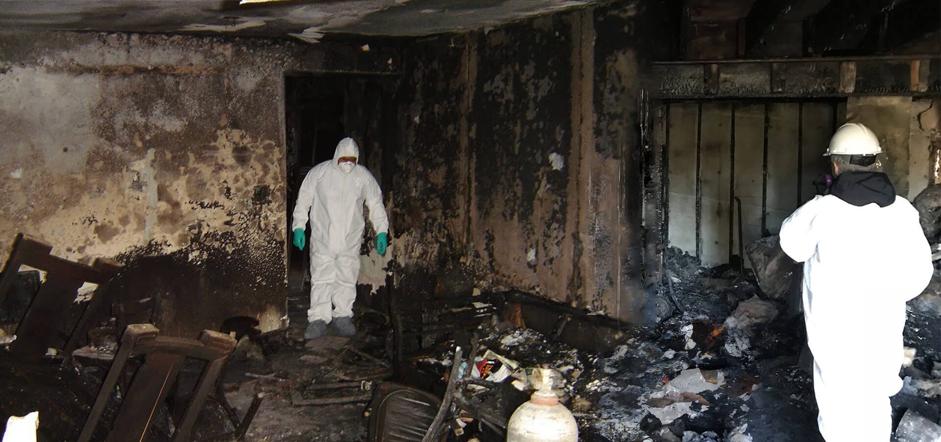 Professional fire and smoke damage restoration technician cleaning soot and smoke residue inside a Melbourne property using HEPA air filtration and specialist restoration equipment.