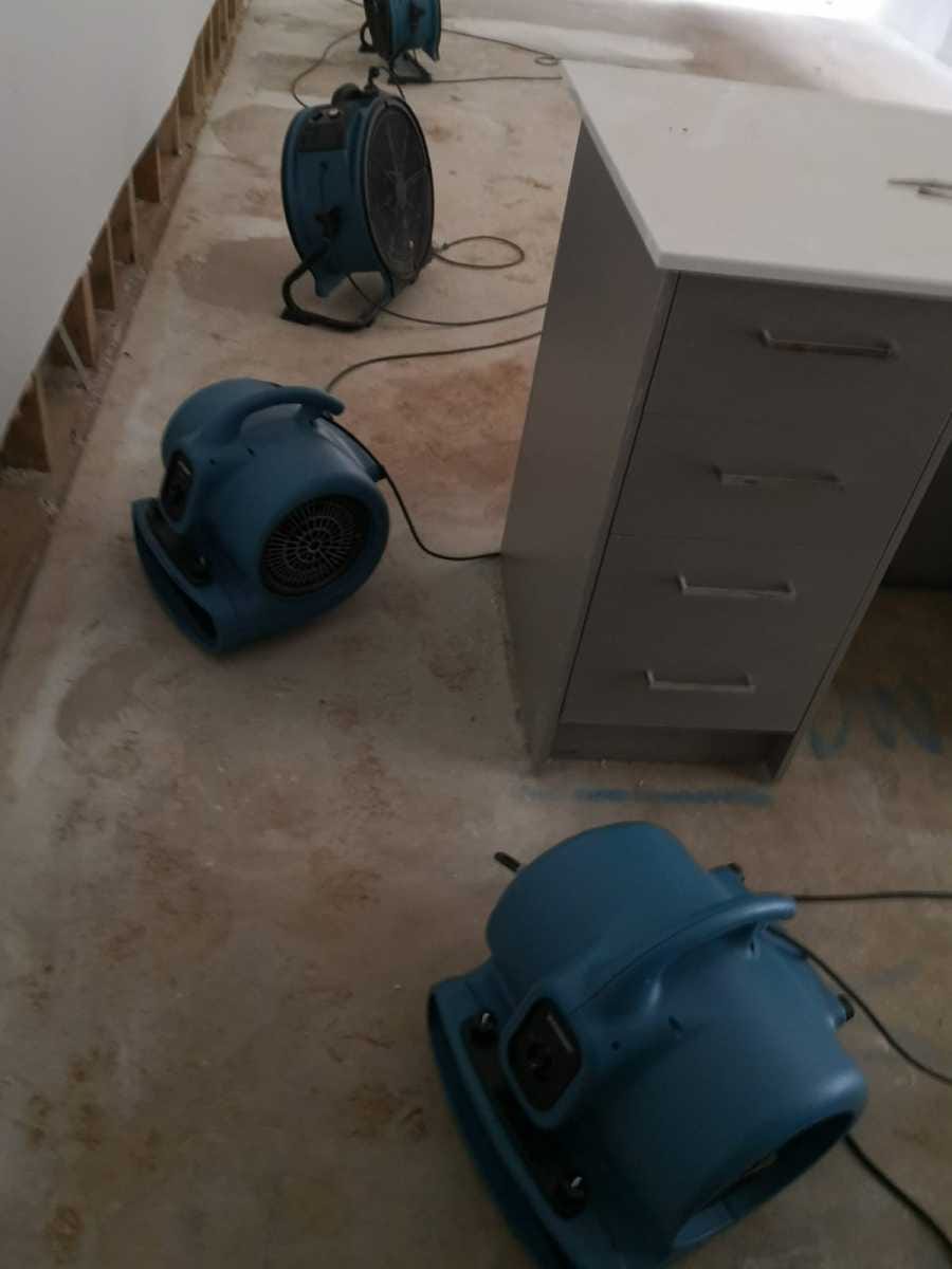 Commercial dehumidifiers and air movers drying a water-damaged Melbourne property