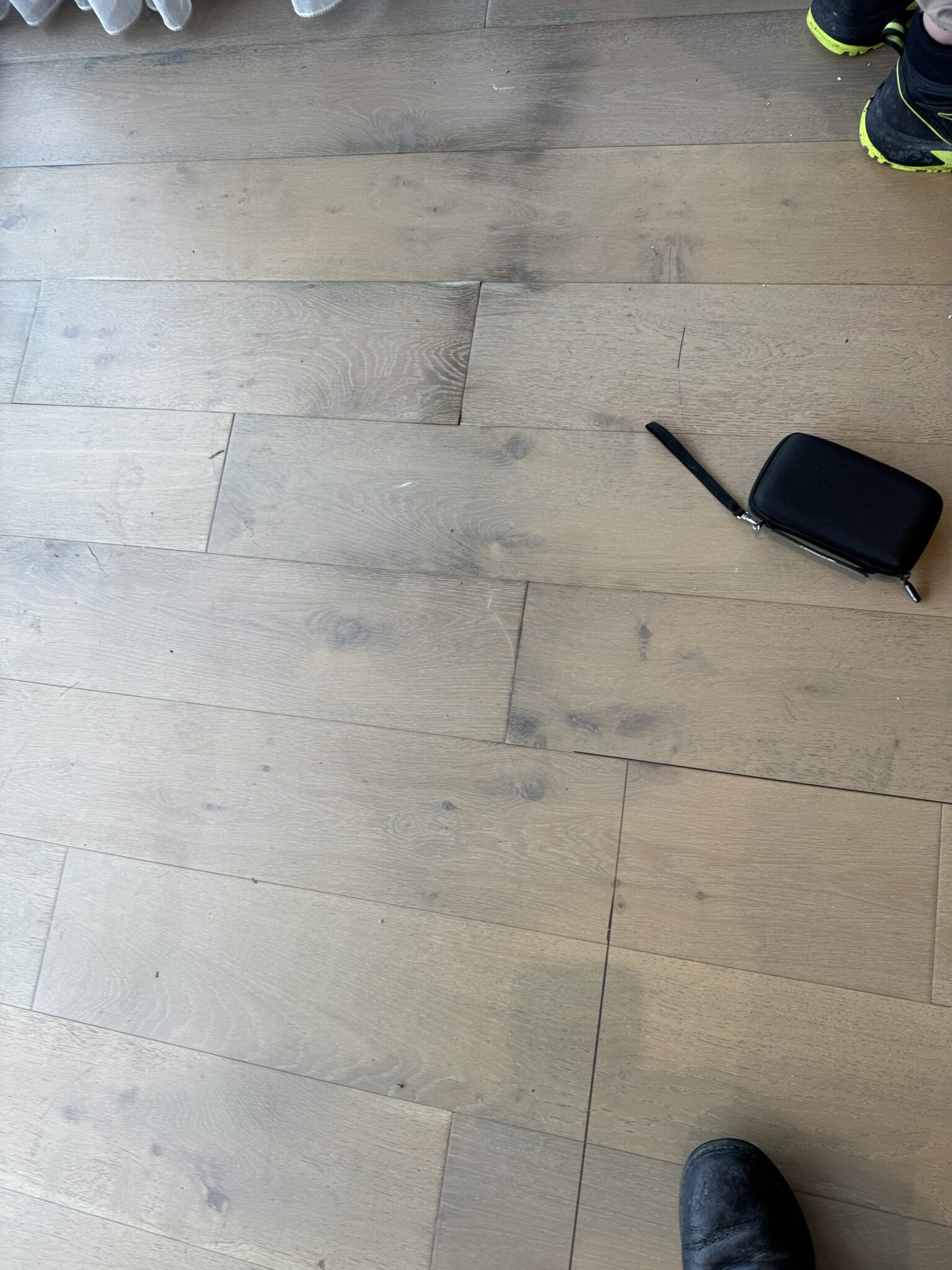Moisture meter showing elevated readings in apartment timber flooring