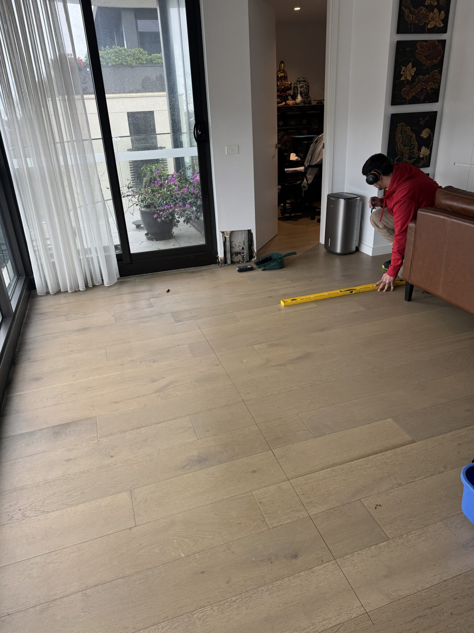 Water-damaged timber flooring inside a Melbourne apartment before restoration